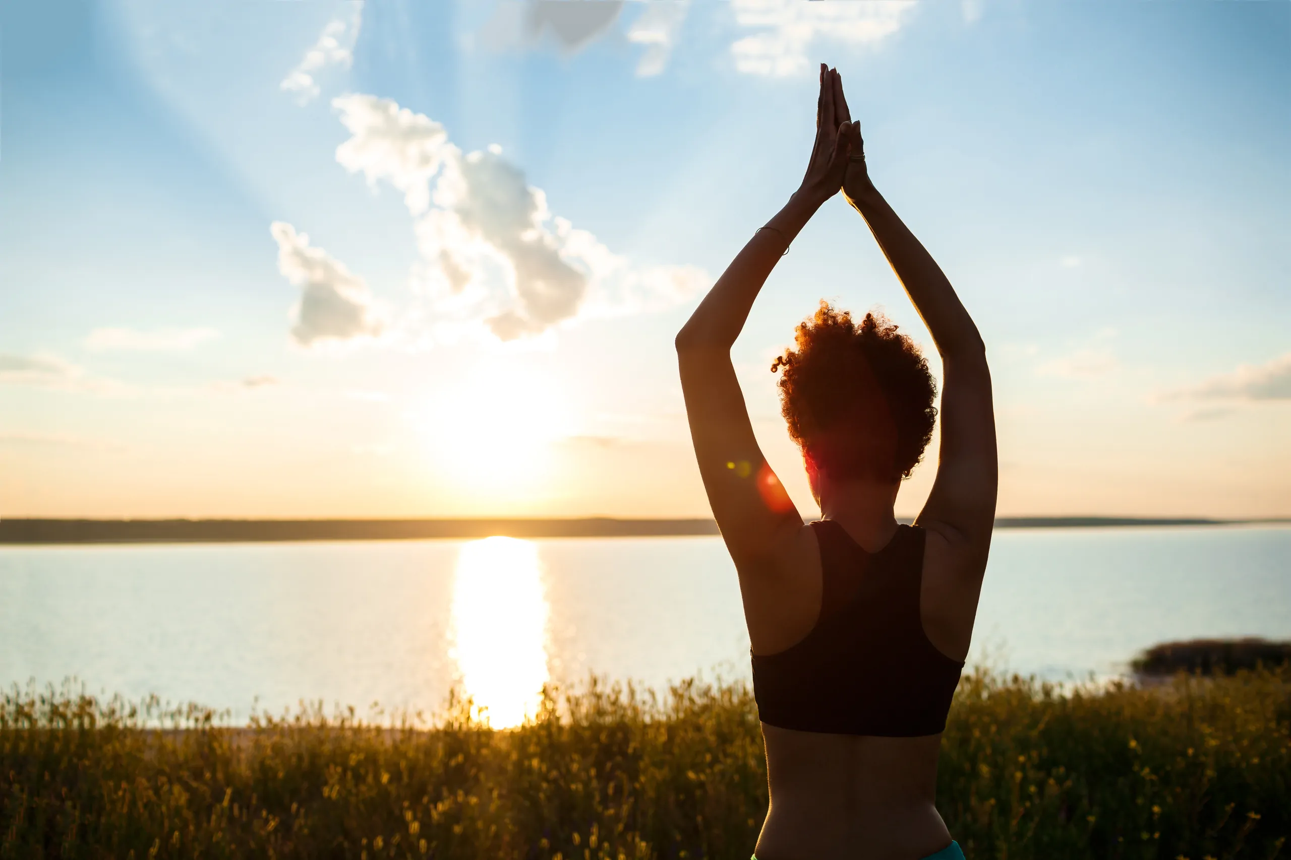 silhouette-sportive-girl-practicing-yoga-field-sunrise